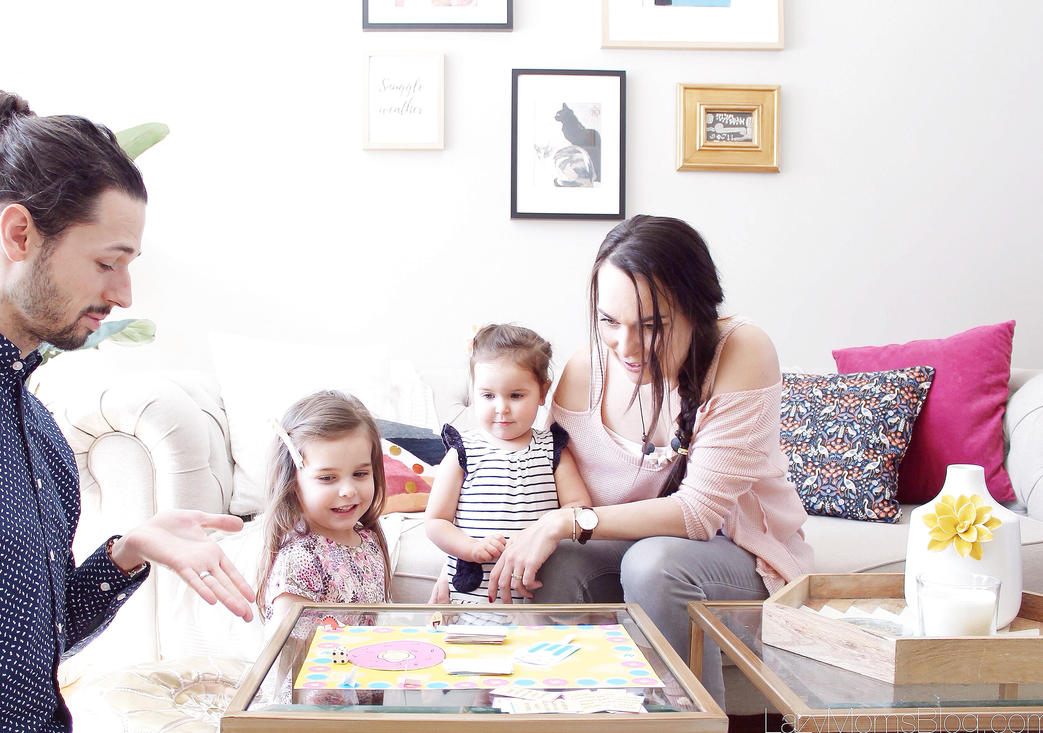 Three siblings playing a cooperative board game together in a cozy living room