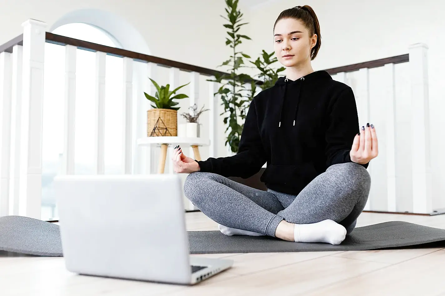 Adult engaged in online therapy session at home