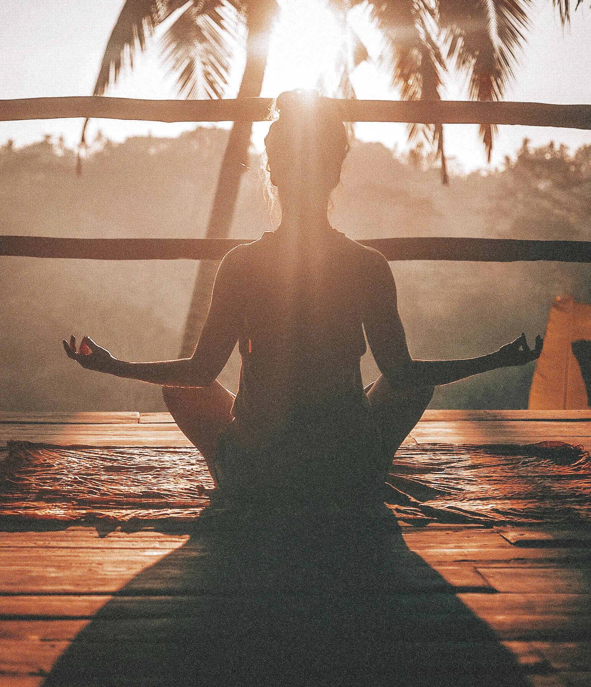 Individual meditating outdoors to build emotional regulation and resilience