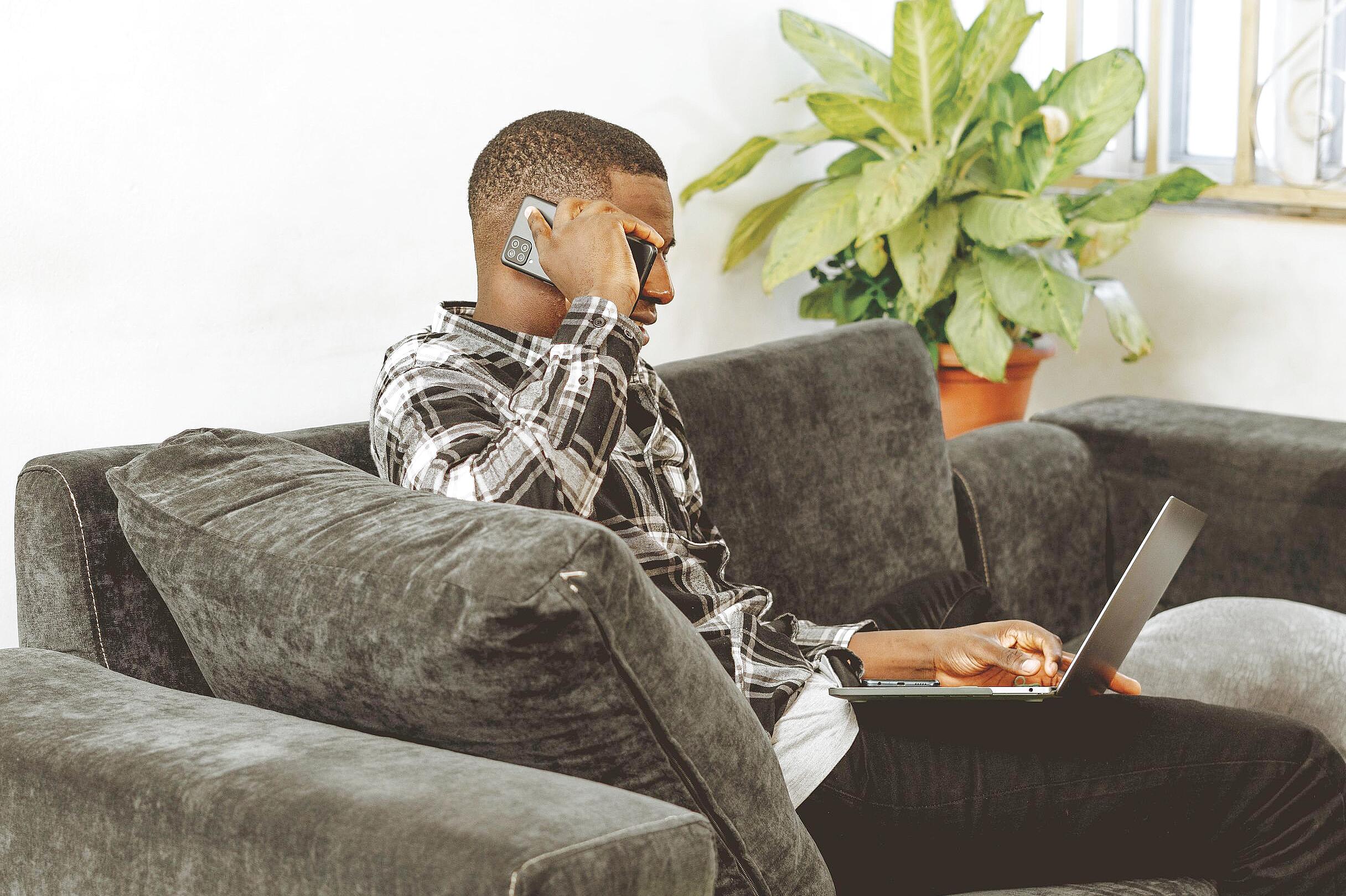 Person connecting with online therapist via laptop at home
