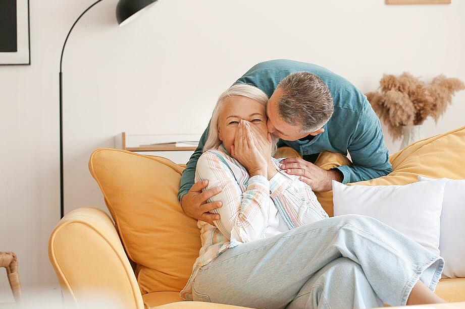 Middle-aged couple sharing affectionate moment at home showing connection