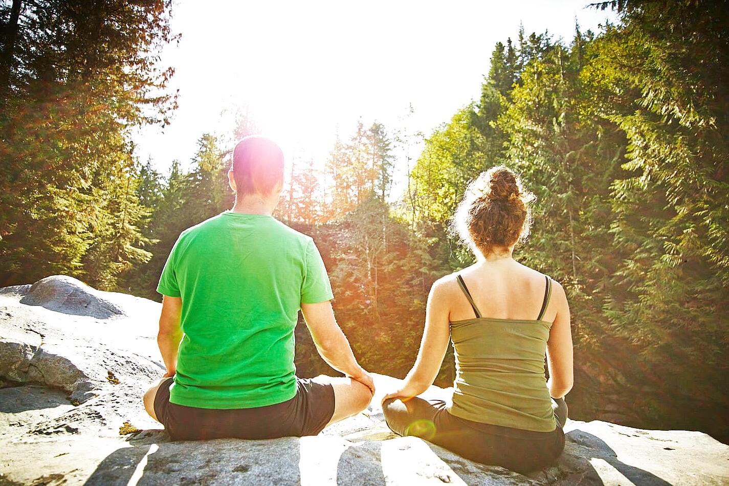 Couple meditating together at home experiencing calm connection