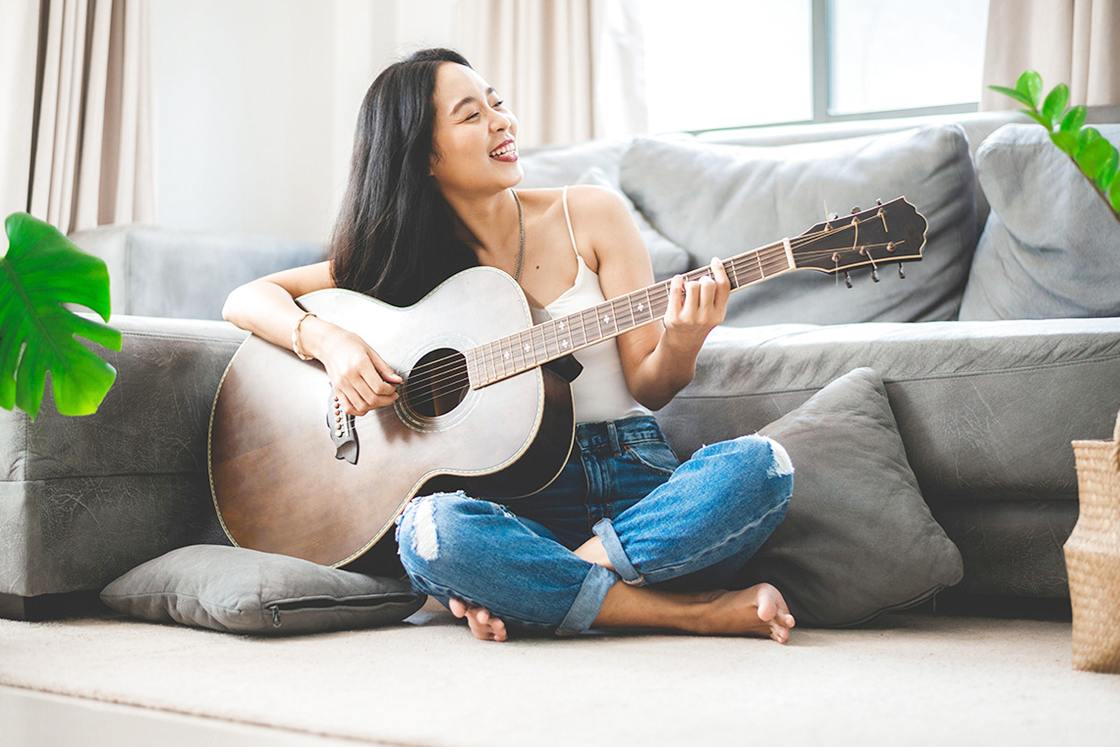 Adult practicing guitar hobby showing personal growth and joy