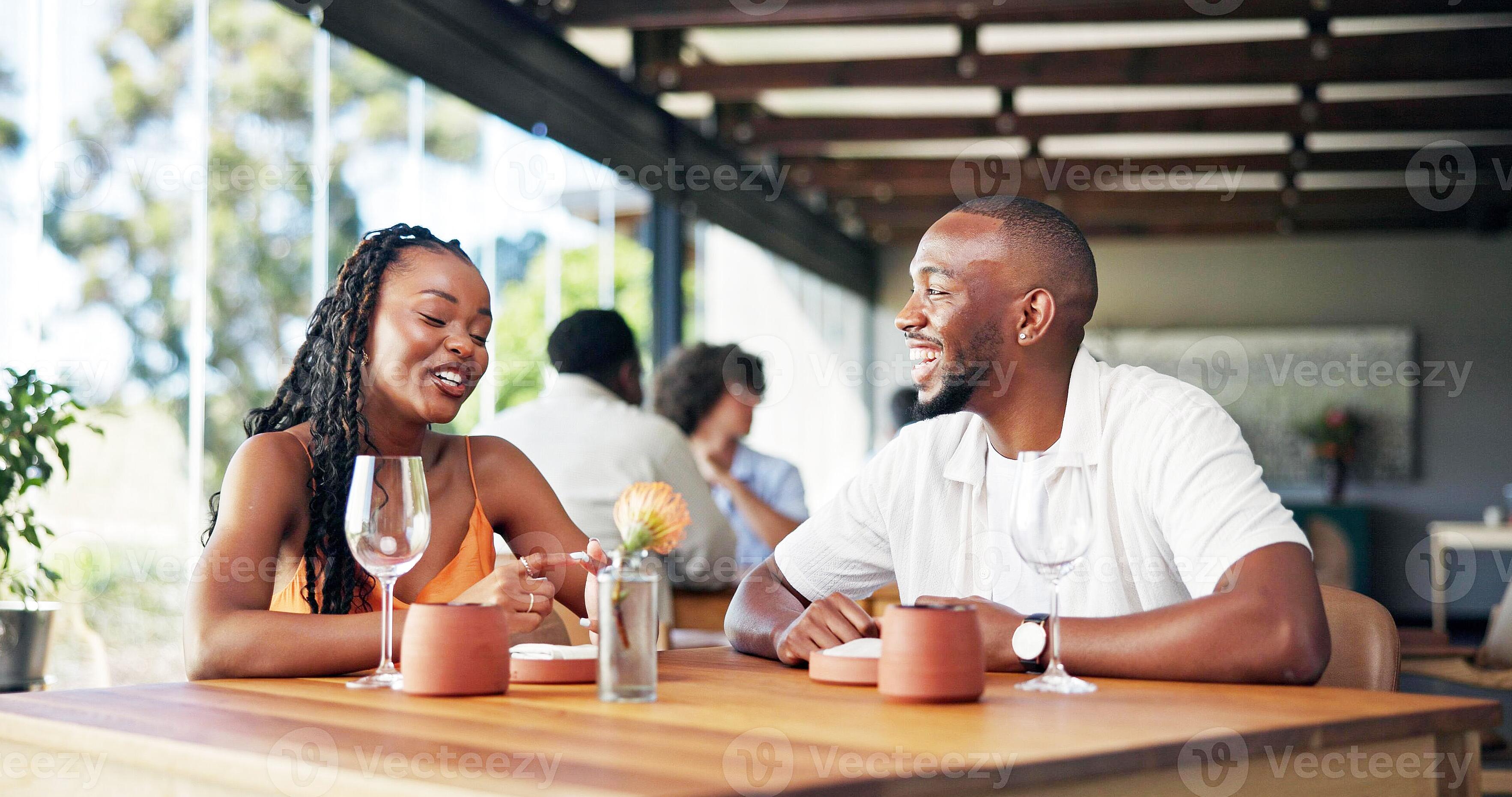 Couple laughing during repeated casual coffee meetups in cafe