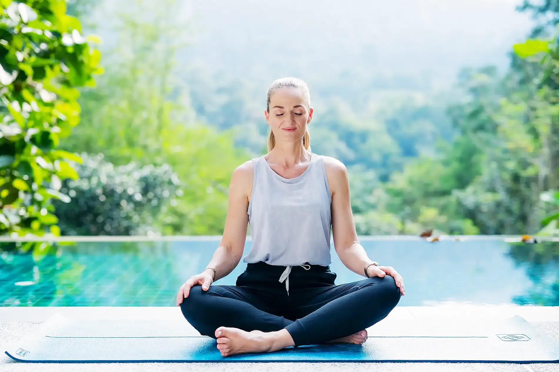 Person practicing trauma-informed meditation with grounding indoors in calm setting