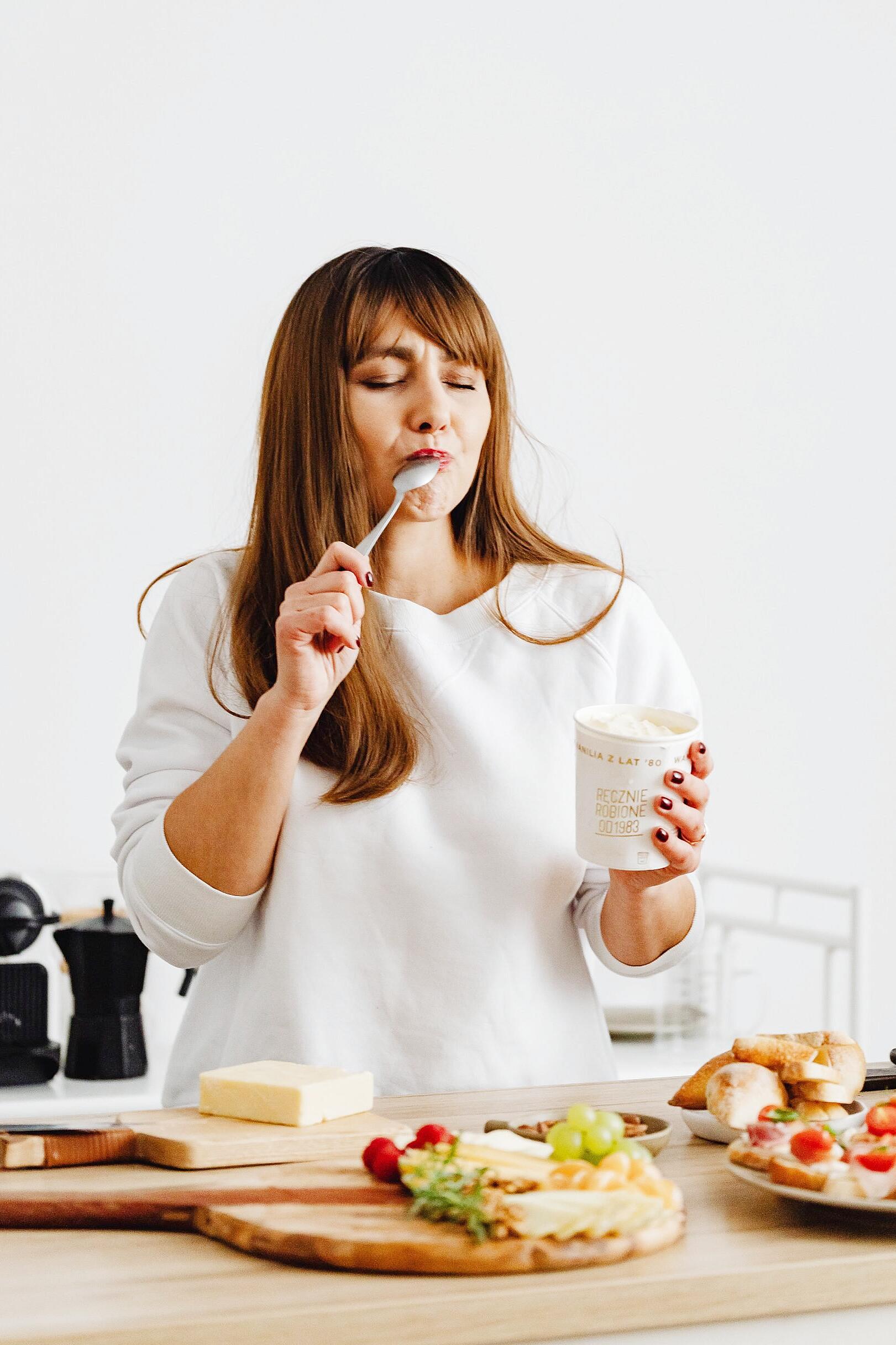 Person eating snack late at night while looking thoughtful
