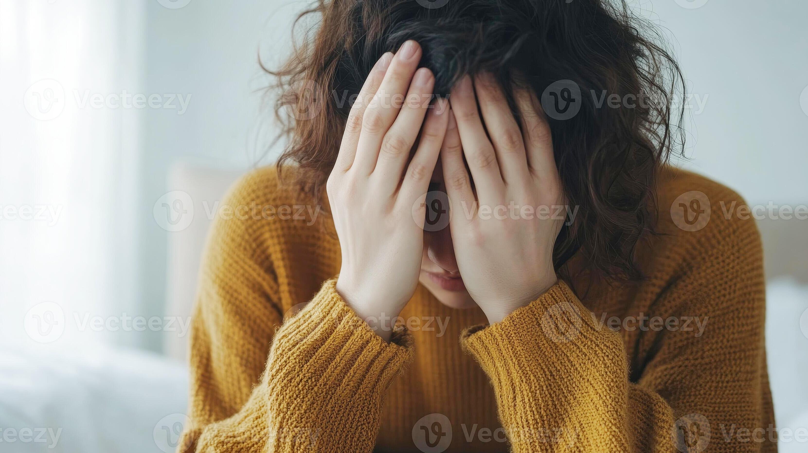 Person quietly reflecting on emotional eating triggers in a soft-lit room