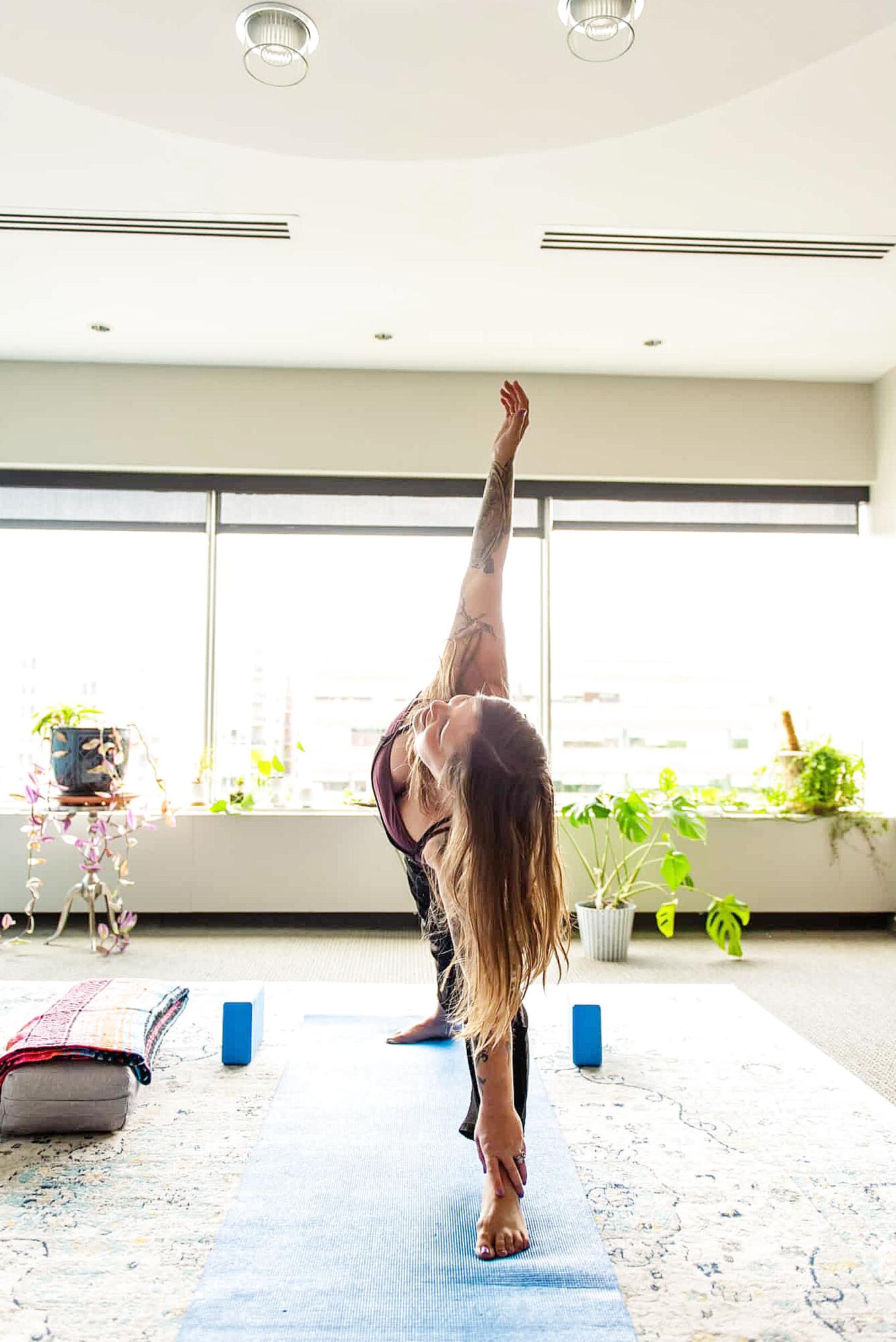 Trauma-sensitive yoga class with gentle stretching in calm studio