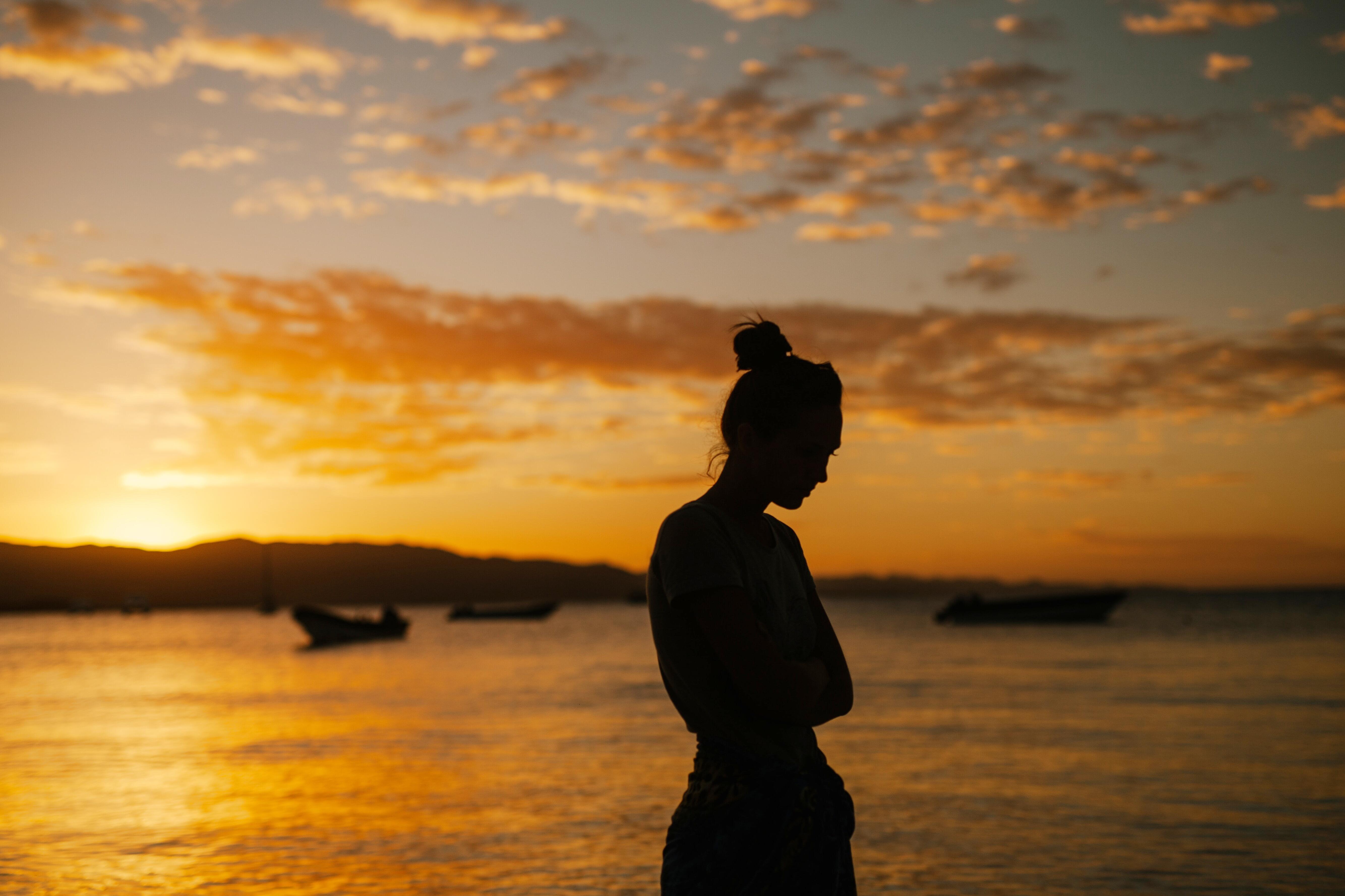 Trauma-sensitive yoga class practicing calm postures outdoors at sunset