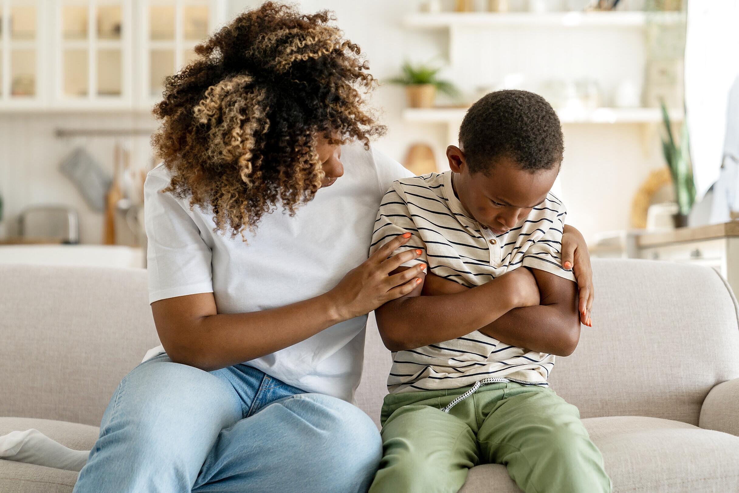 Parent and child sharing a supportive emotional moment at home