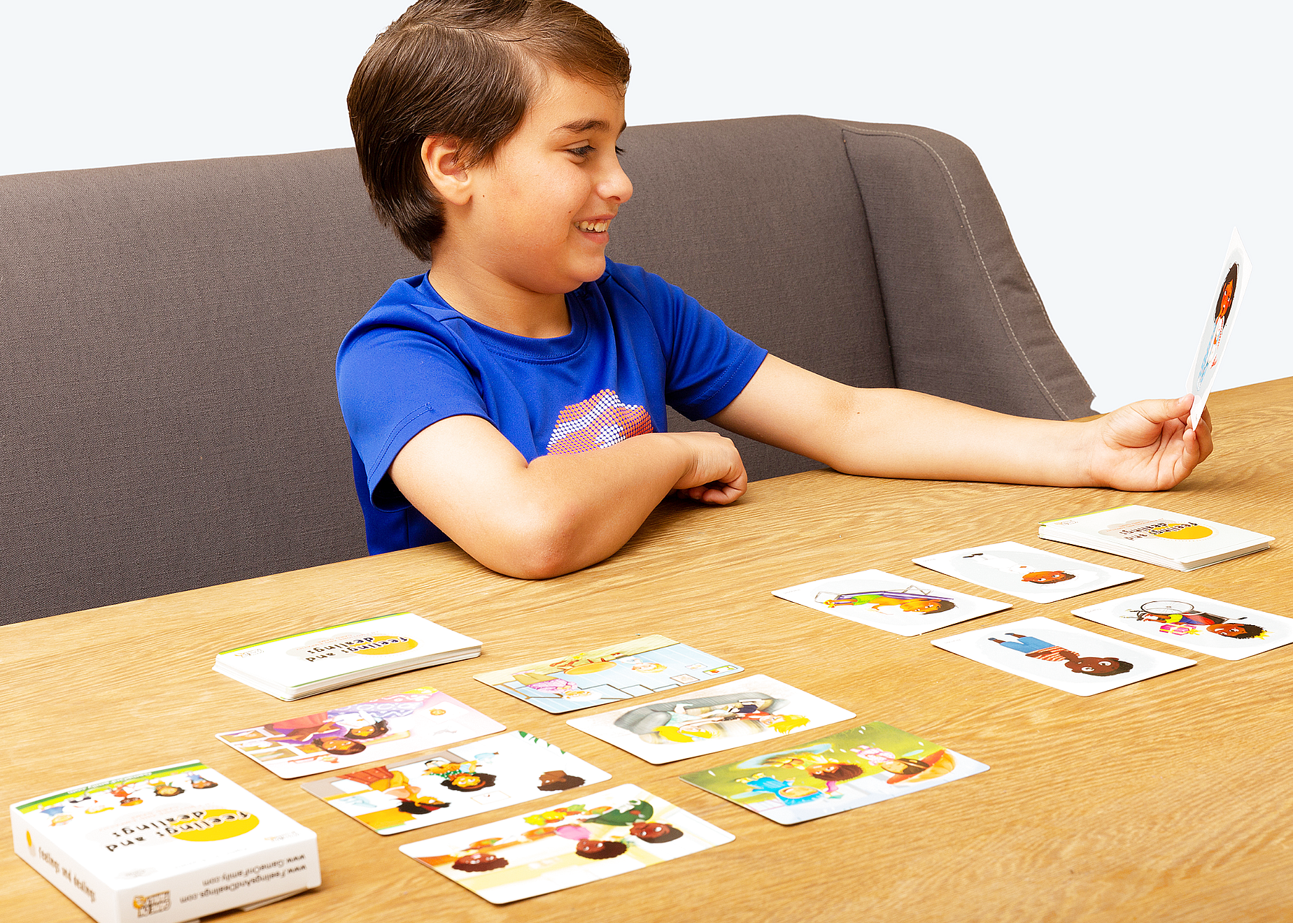 Parent and child engaged in emotion card game together