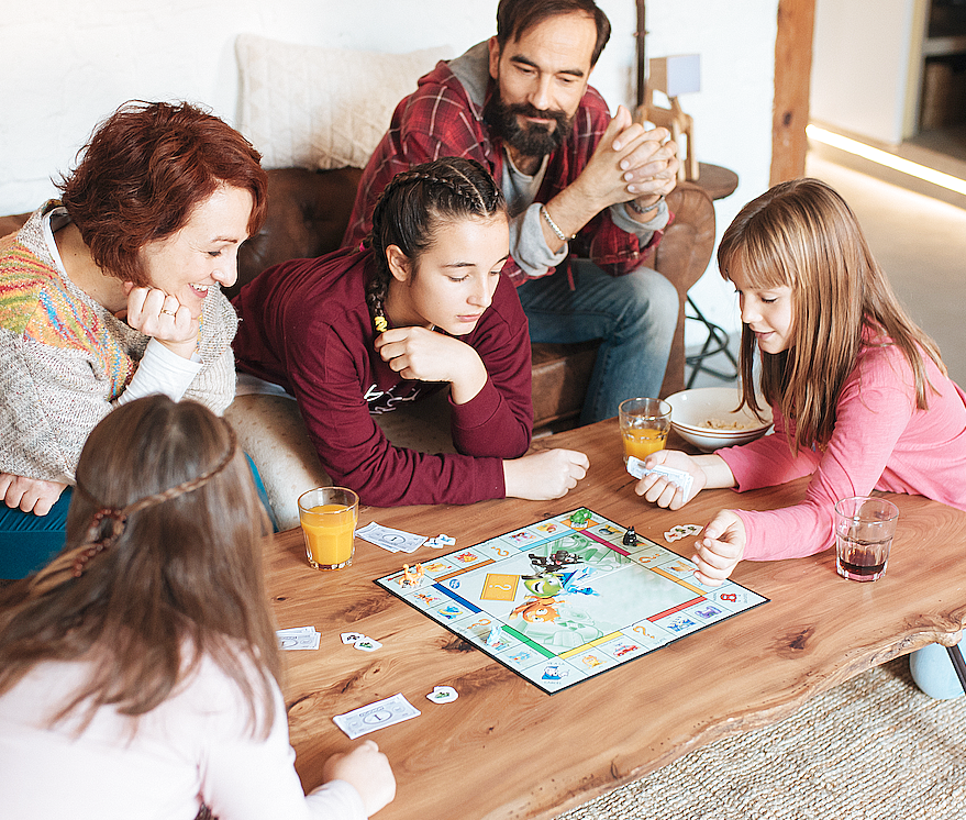 Family having fun playing board games together at home