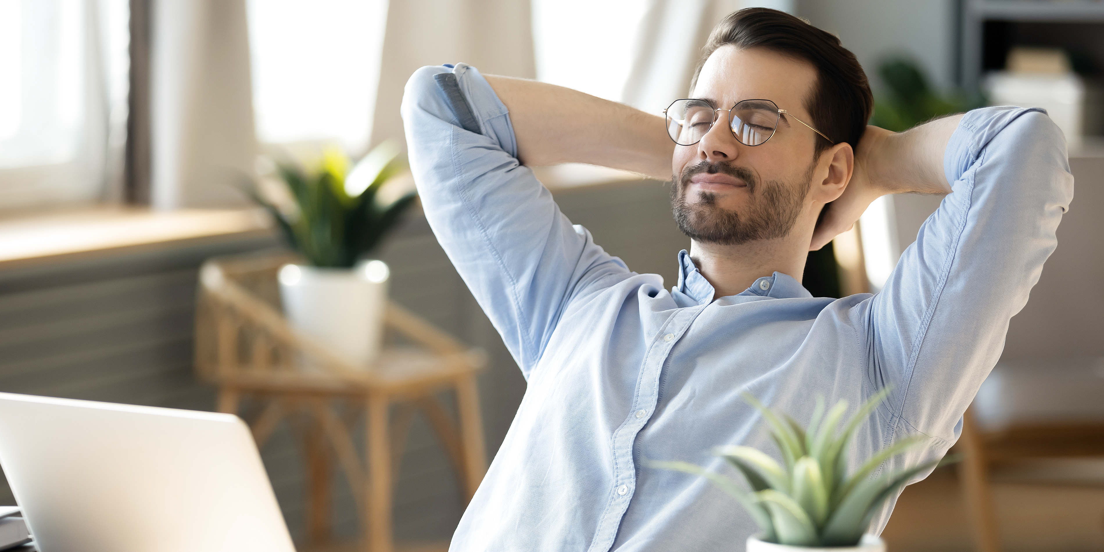 Adult practicing quick mindful breathing at office desk to reduce stress
