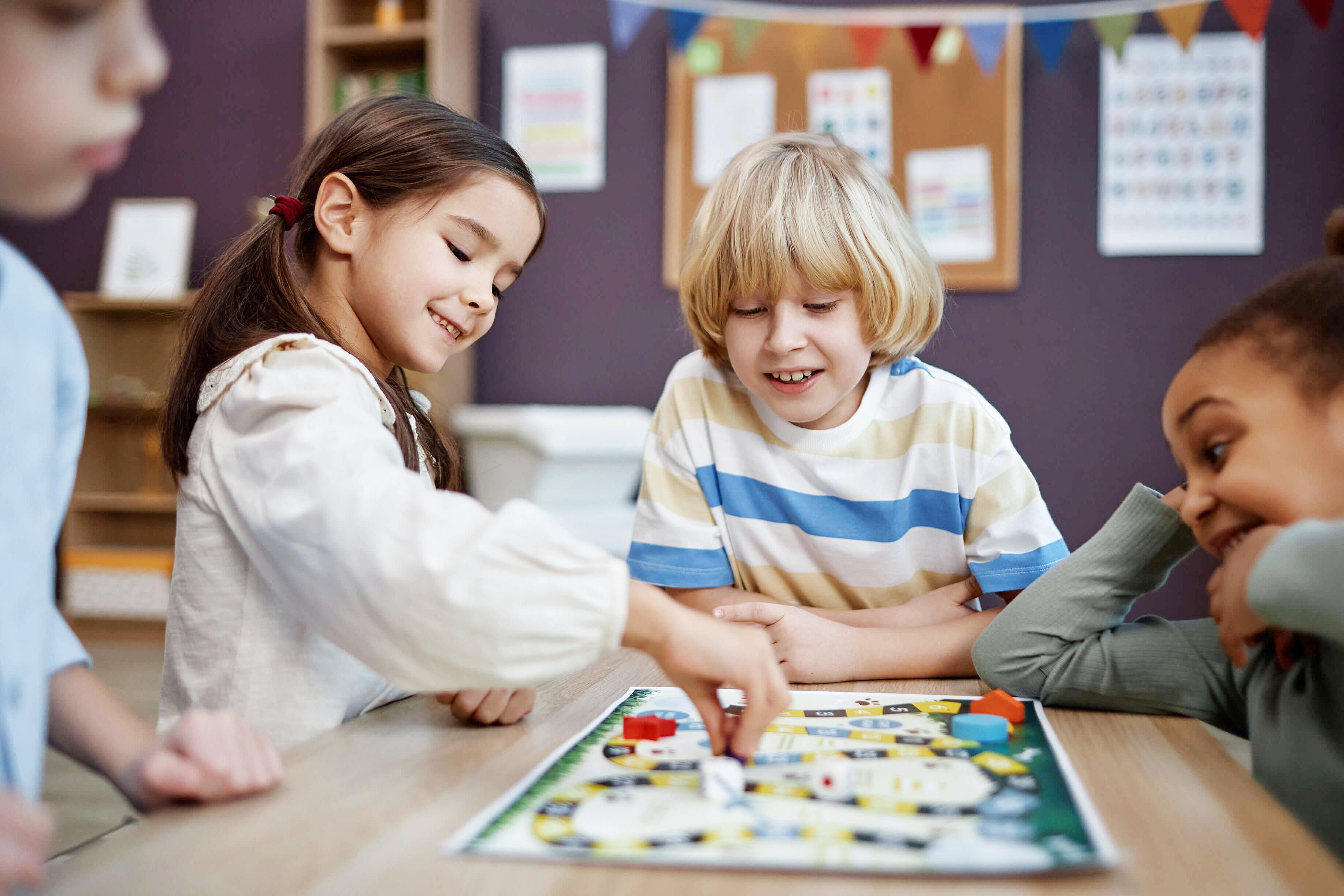 Siblings working together on a puzzle game at home